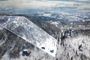 Snowy aerial view with property boundaries highlighted and a mountain view
