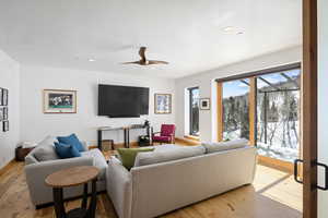 Living room featuring wood-type flooring, recessed lighting, and ceiling fan