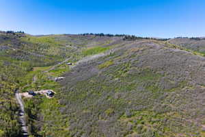 View of property location featuring a forest