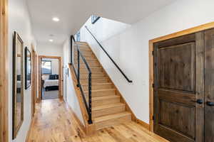 Staircase with wood-type flooring, recessed lighting, and baseboards