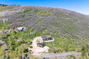 View of property location featuring a heavily wooded area and a mountainous background