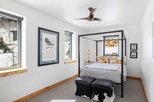 Bedroom with carpet, baseboards, and a ceiling fan