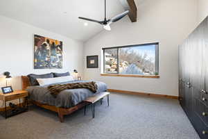 Bedroom with carpet floors, baseboards, beam ceiling, a ceiling fan, and high vaulted ceiling