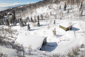 Snowy aerial view featuring a mountain view