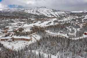 Snowy aerial view featuring a mountain view