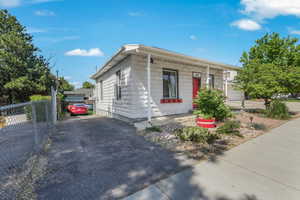 View of front of home featuring fence and covered porch