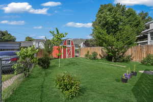 View of yard with an outbuilding and a storage unit