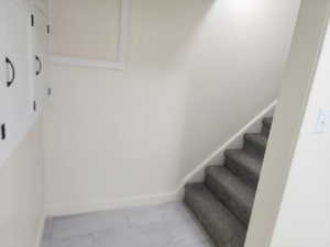 Stairway featuring baseboards
