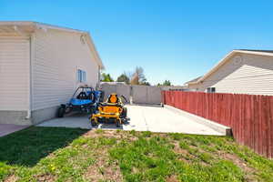 View of yard with fence and a patio