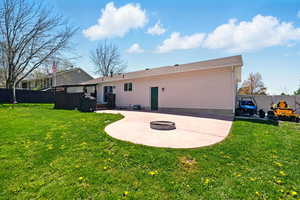 Back of property with a patio area and an outdoor fire pit