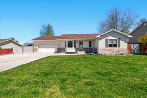Ranch-style home featuring driveway, an attached garage, and brick siding