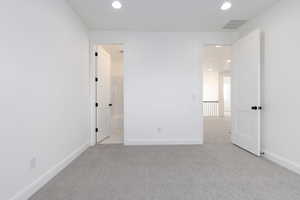 Unfurnished bedroom featuring recessed lighting, baseboards, and carpet flooring