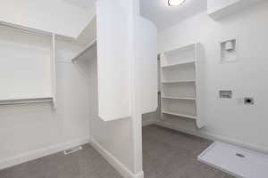 Walk in closet featuring carpet flooring