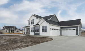 View of front of home featuring an attached garage, concrete driveway, brick siding, and roof with shingles