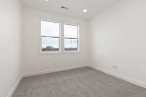 Carpeted empty room featuring baseboards and recessed lighting
