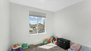 Game room featuring carpet floors and baseboards
