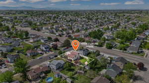 Aerial view of residential area featuring property parcel outlined and mountains