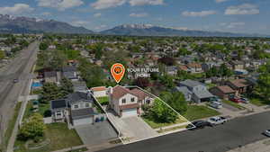 Aerial perspective of suburban area featuring property boundaries highlighted and a mountain backdrop