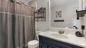 Full bathroom with vanity and toilet