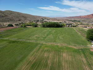 Aerial view of property's location with rural landscape and a mountainous background
