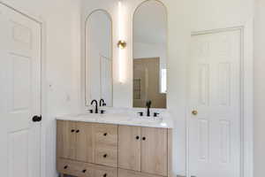 Bathroom with double vanity and vaulted ceiling