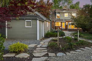 Back of house featuring an outbuilding and brick siding