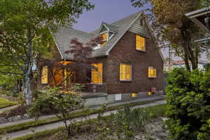 View of front of house with brick siding and a shingled roof