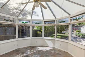 Unfurnished sunroom featuring healthy amount of natural light and baseboards