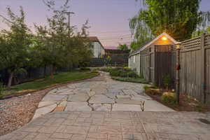 Yard at dusk featuring a patio