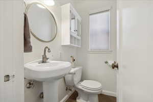 Bathroom featuring toilet and baseboards