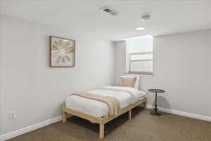 Carpeted bedroom with baseboards