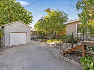 Detached garage with driveway and fence