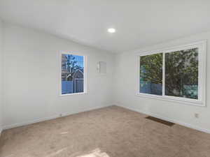 Unfurnished room featuring carpet flooring, baseboards, and recessed lighting