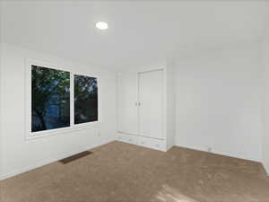 Carpeted empty room with baseboards