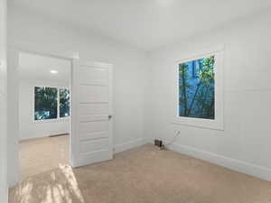Carpeted empty room with baseboards