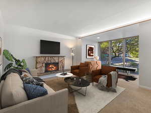 Living area with carpet floors and a fireplace