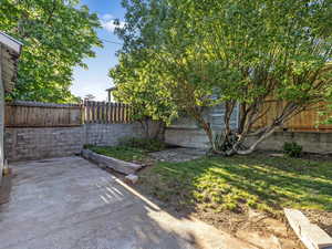 Fenced backyard with a patio or RV pad