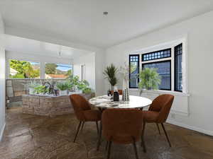 Dining room with stone tile flooring and plenty of natural light