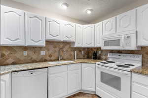 Kitchen with Newly Painted White Cabinets