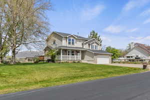 Traditional home with a porch and driveway