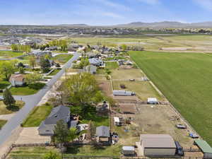 Aerial view of property and surrounding area with a mountain backdrop