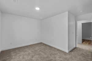 Carpeted empty room with baseboards