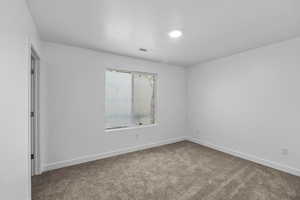 Empty room with carpet floors and baseboards