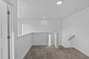 Basement featuring carpet floors, baseboards, and recessed lighting