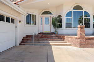 Entrance to property with stucco siding