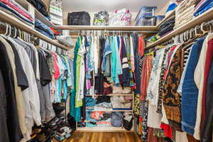 Walk in closet featuring wood finished floors