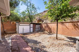 Fenced backyard featuring an outdoor structure and a mountain view
