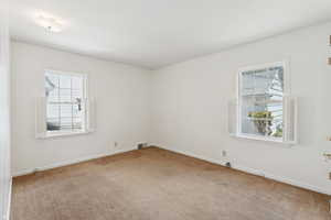 Carpeted empty room with baseboards