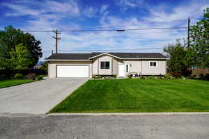 Ranch-style house with driveway and a garage