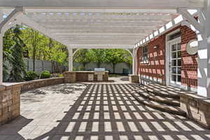 View of patio with a fenced backyard and a pergola